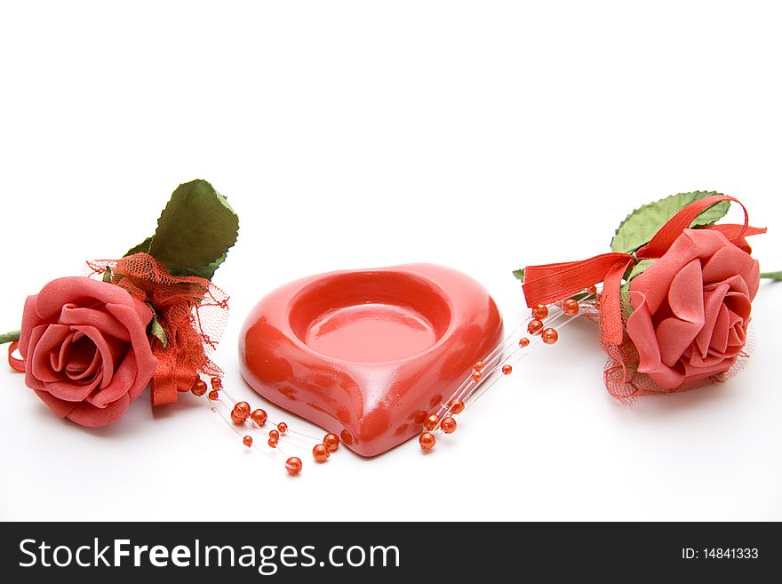 Red rose blossoms with ceramics heart. Red rose blossoms with ceramics heart