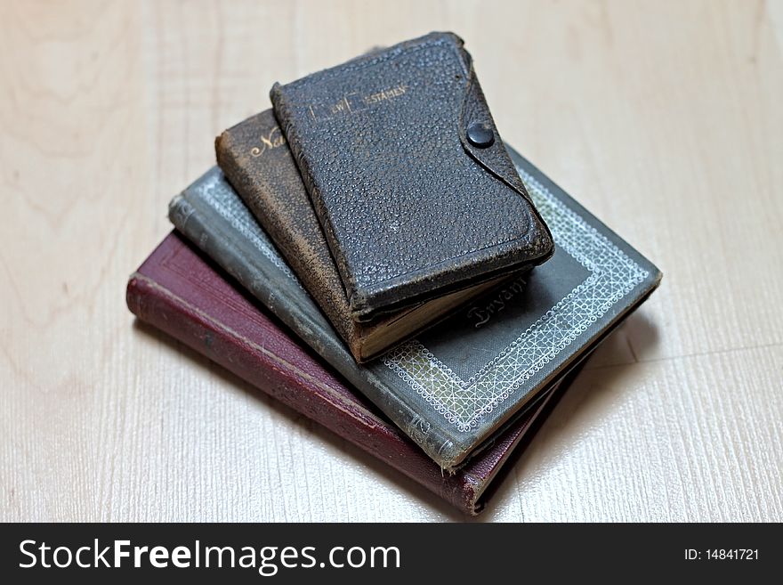 Stack of dusty worn books on poetry and and a bible