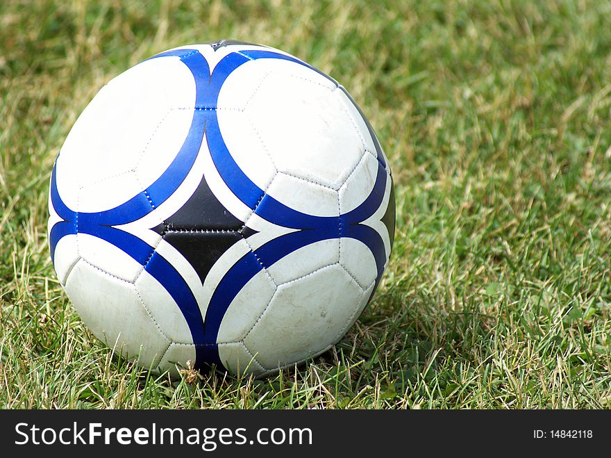 A soccer ball sits on the field of grass. A soccer ball sits on the field of grass.