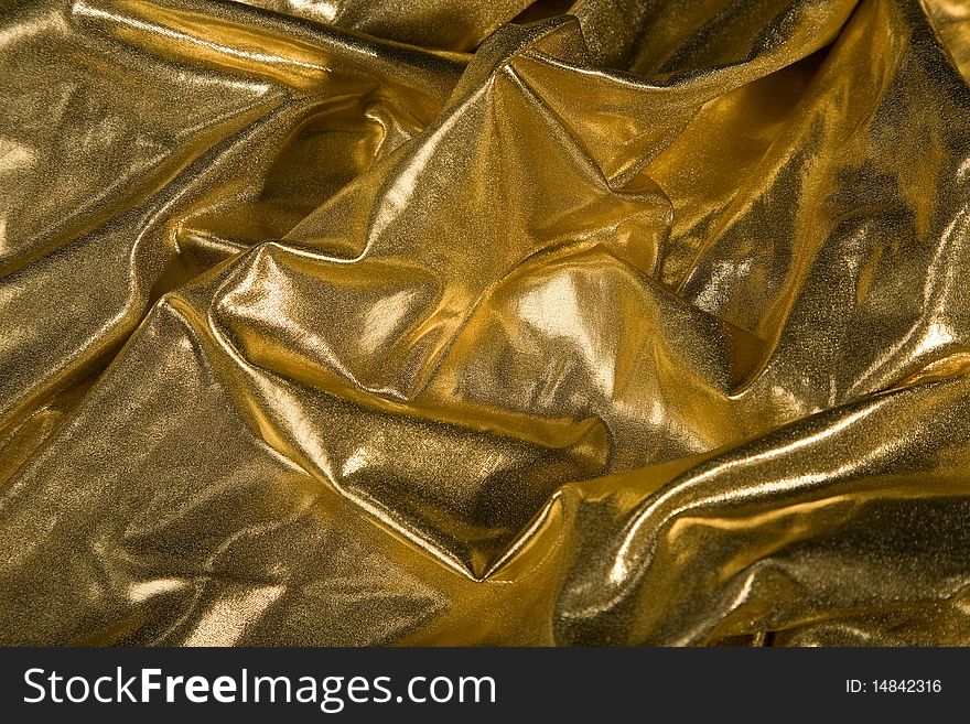 Close-up picture of elegant gold fabric fold. Close-up picture of elegant gold fabric fold