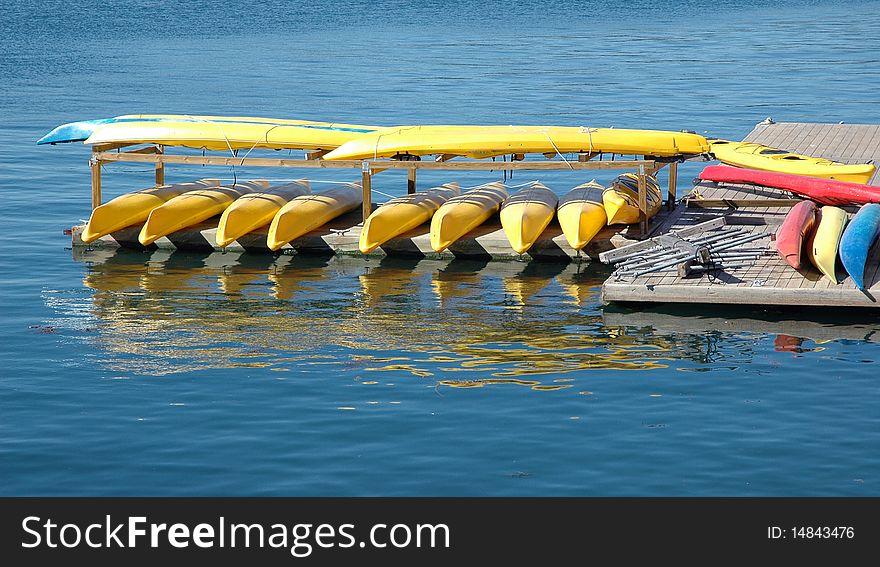 Ocean kayak rental dock reflecting in the water.