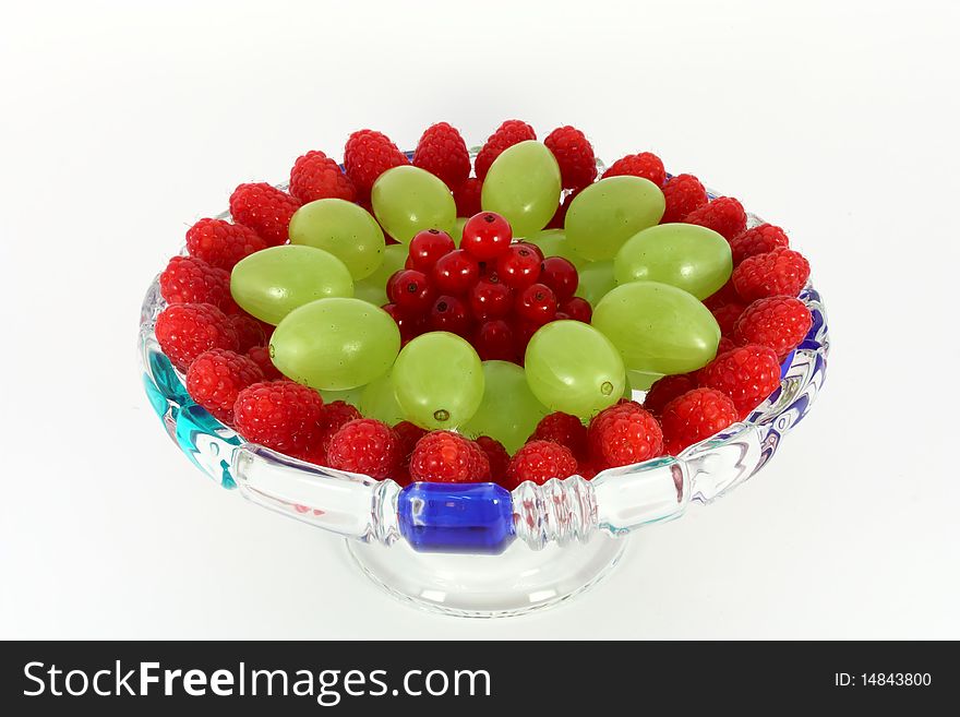 Mix of fruit on the plate isolated on white