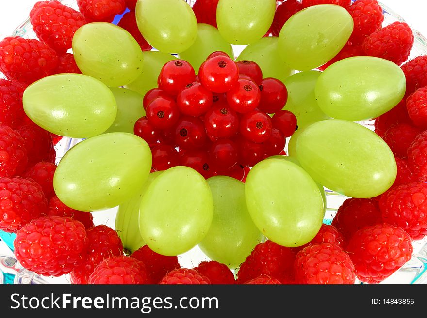 Mix of fruit on the plate isolated on white