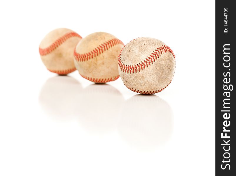 Three Baseballs Isolated on a Reflective White Background. Three Baseballs Isolated on a Reflective White Background.