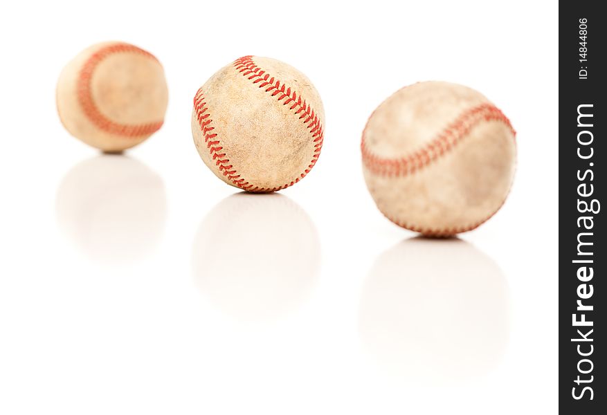 Three Baseballs Isolated on a Reflective White Background. Three Baseballs Isolated on a Reflective White Background.