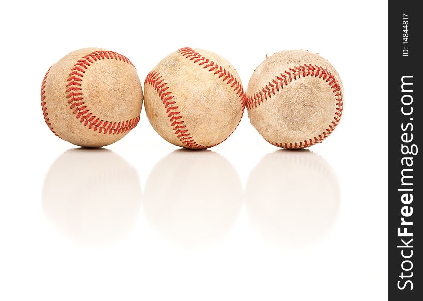 Three Baseballs Isolated on a Reflective White Background. Three Baseballs Isolated on a Reflective White Background.