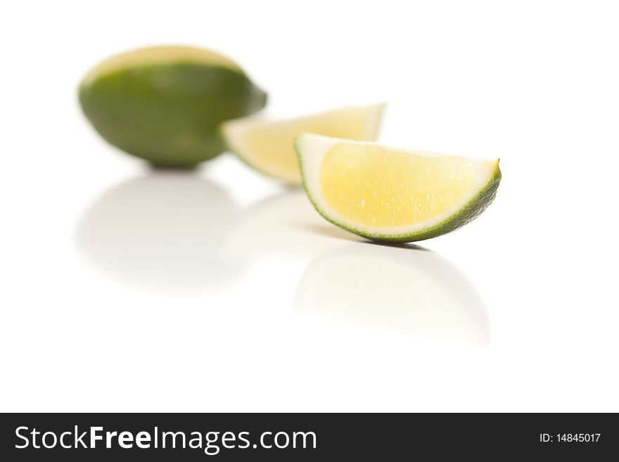 Sliced Lime on a Reflective White Surface.