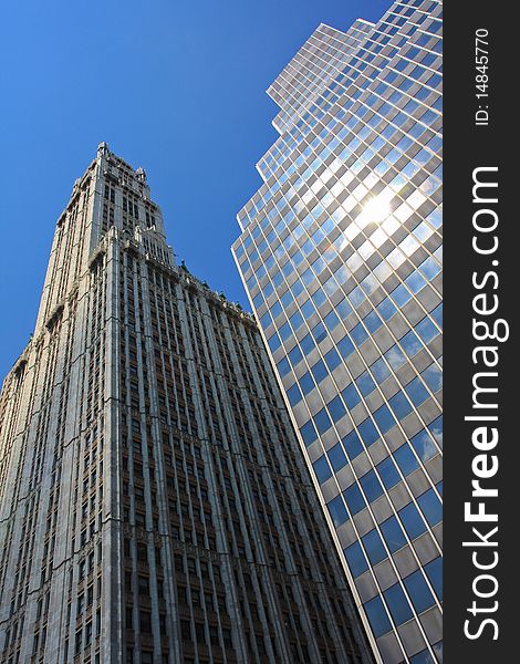 Two skyscrapers of different eras are proudly standing under the New York sun. Two skyscrapers of different eras are proudly standing under the New York sun.