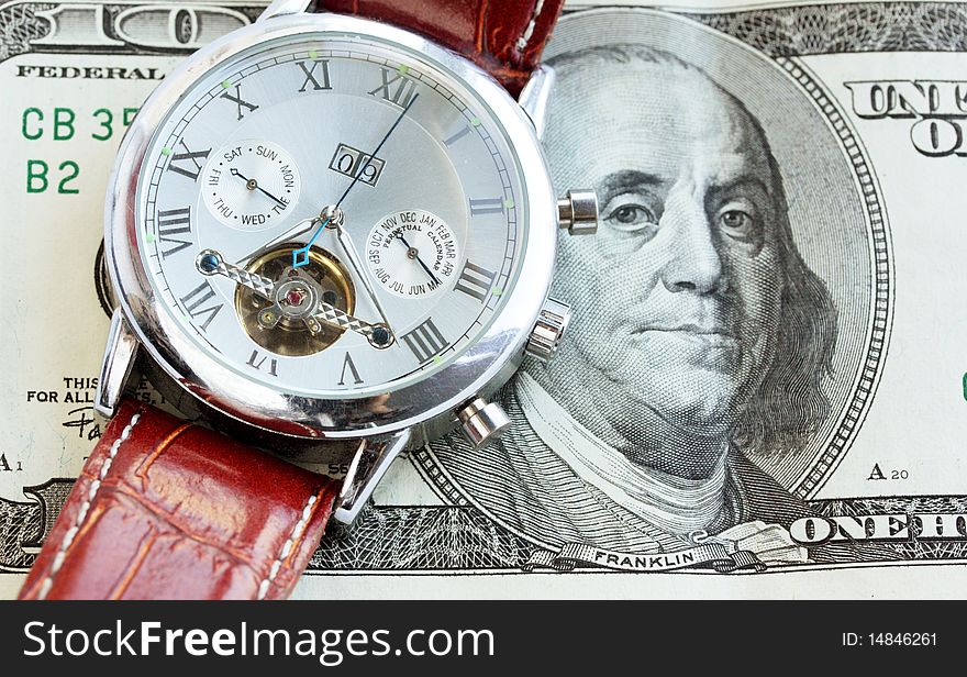 Wrist watch lie on the money / time is money