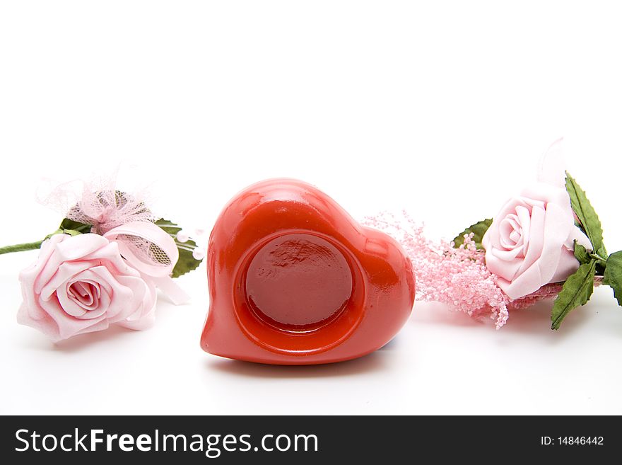 Pink rose blossoms with ceramics heart. Pink rose blossoms with ceramics heart