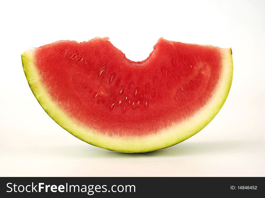 Bitten piece of watermelon on the white background