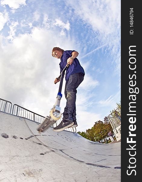 Young boy going airborne with scooter