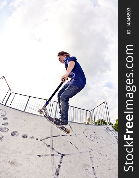 Young Boy Going Airborne With Scooter