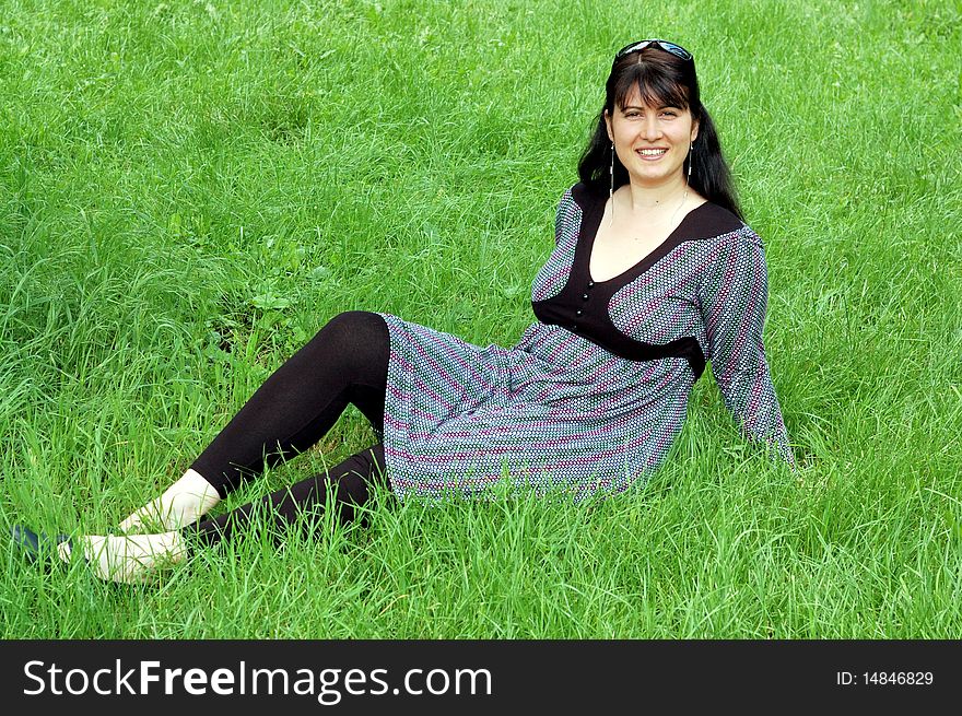 Beautiful young woman relaxing in the grass