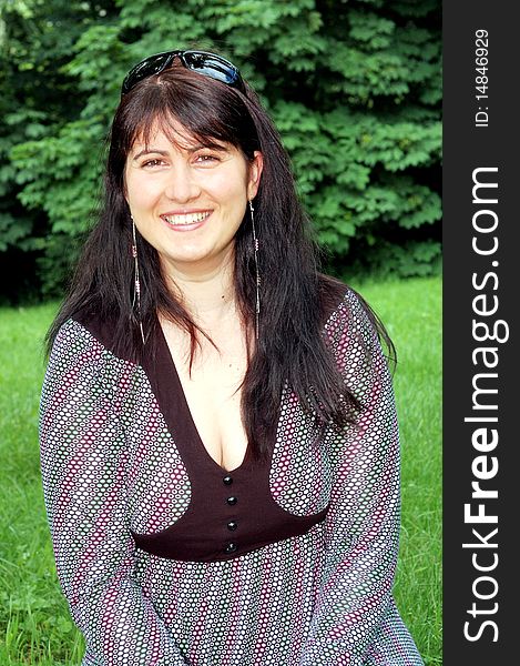 Portrait of beautiful woman in a green park. Portrait of beautiful woman in a green park