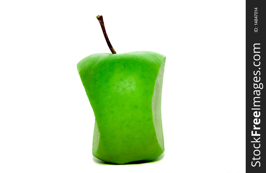 The green apple, which was cut off by a knife from two parties (rest - bit). The green apple, which was cut off by a knife from two parties (rest - bit)