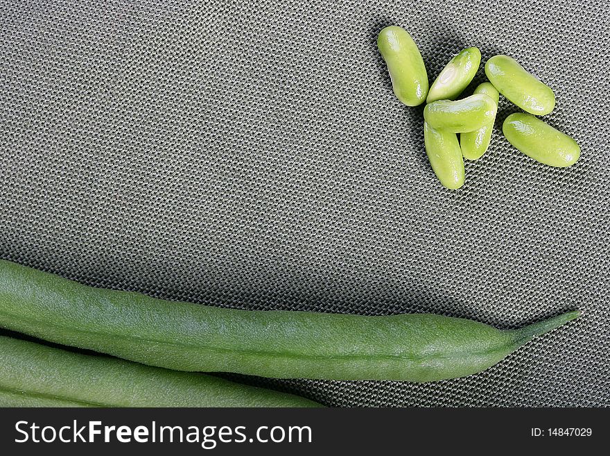 Fruits asparagus bean beans against a grey napkin.