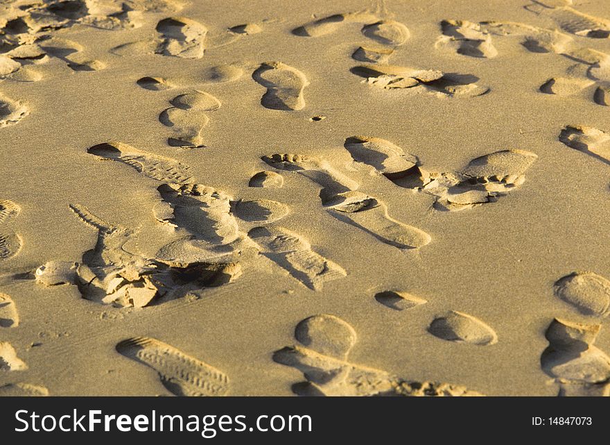 Marks of footspeps in fine sand at the beach