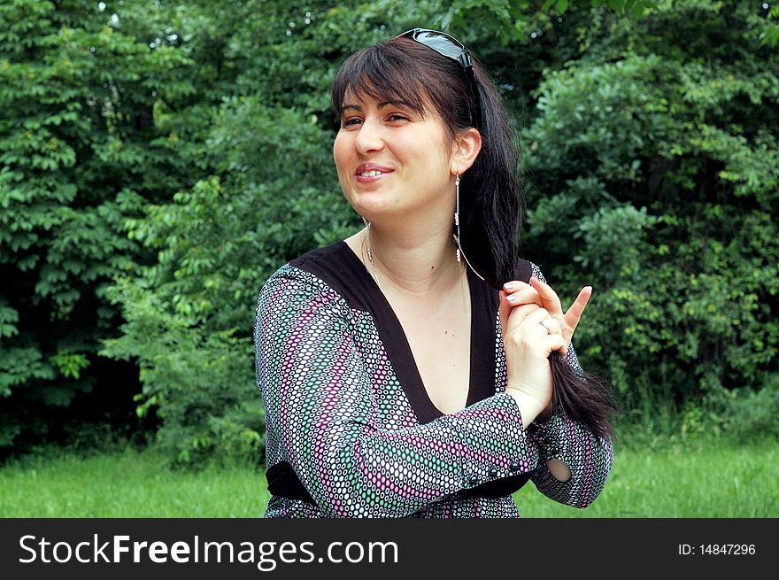 Portrait of beautiful woman in a green park. Portrait of beautiful woman in a green park
