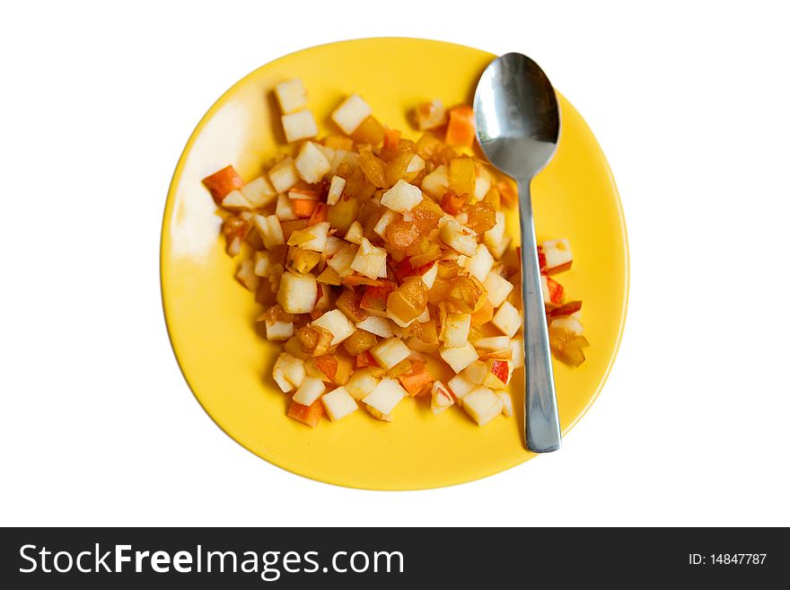 Fruit salad on yellow plate with a spoon isolated on white. Fruit salad on yellow plate with a spoon isolated on white