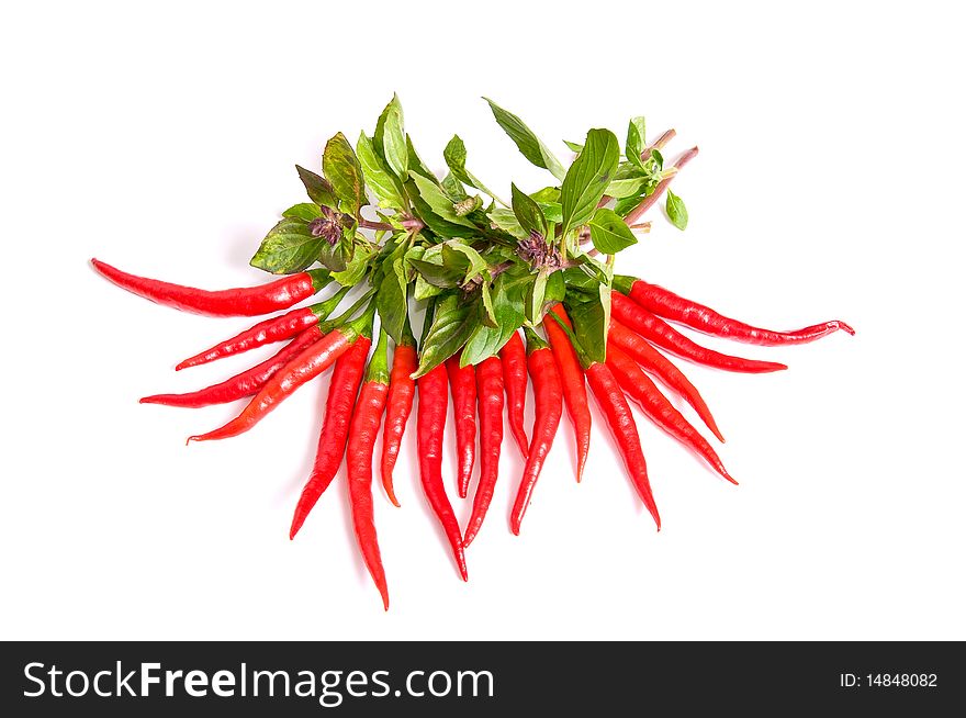 Herb of basil and red peppers isolated on a white background. Herb of basil and red peppers isolated on a white background.