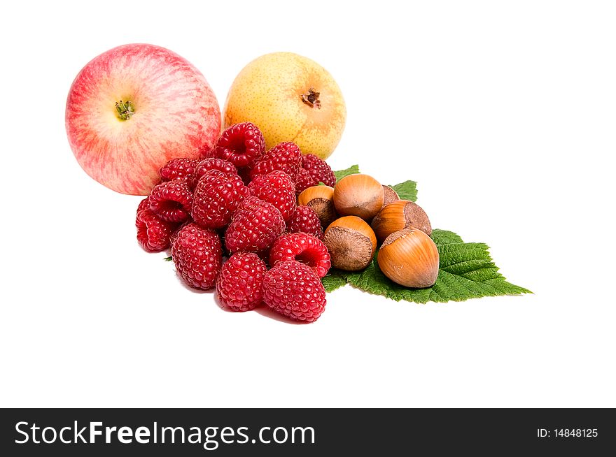 Tasty ripe apple,hazelnuts,pear and raspberries isolated on a white background. Tasty ripe apple,hazelnuts,pear and raspberries isolated on a white background.