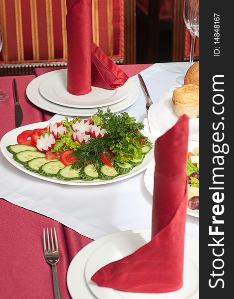 Tablewares and vegetables on a celebratory table. Tablewares and vegetables on a celebratory table.