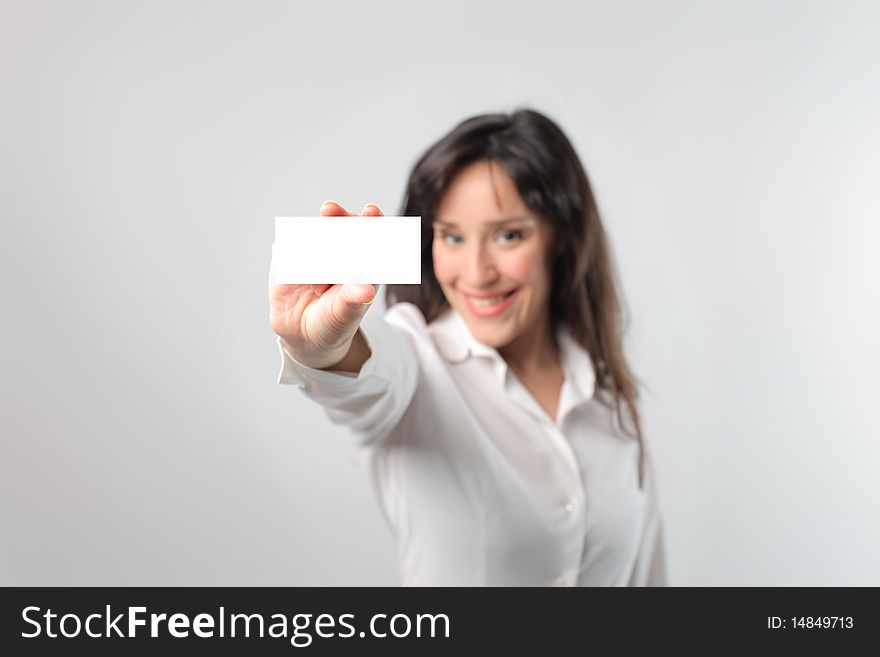 Smiling young woman showing a business card