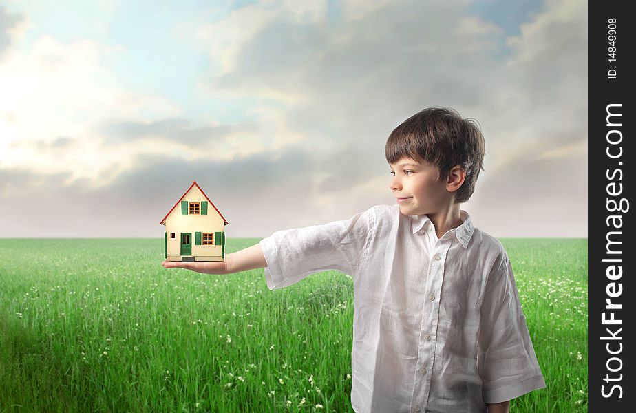 Smiling child holding the model of a house. Smiling child holding the model of a house