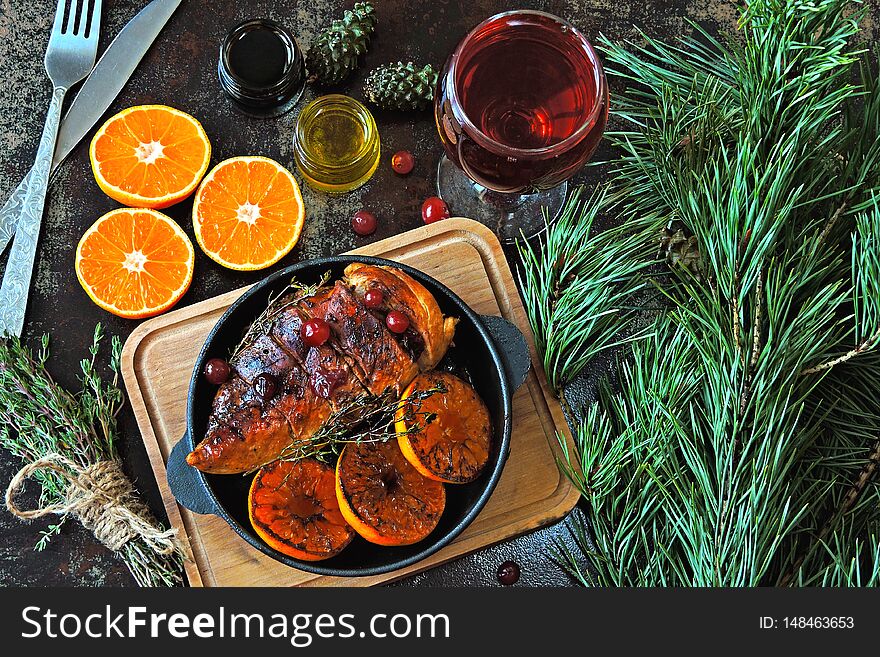 Christmas dinner. Chicken breast baked with tangerines and cranberries. glass of wine. Christmas moo