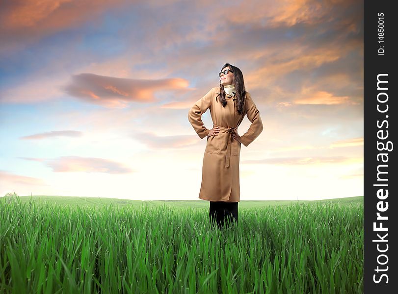 Smiling woman standing on a green meadow. Smiling woman standing on a green meadow