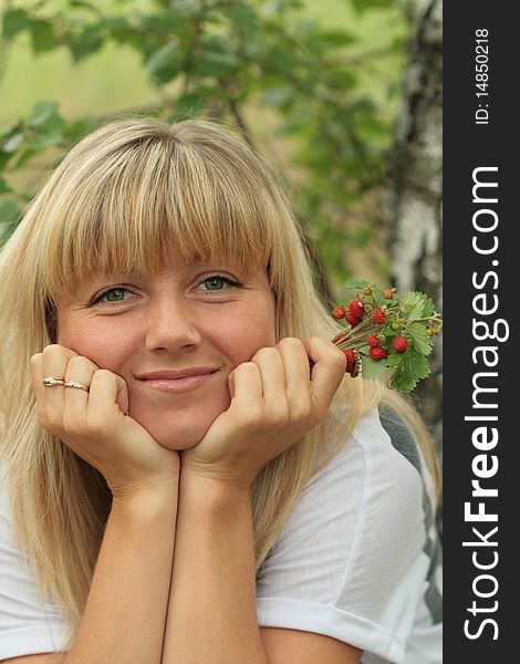 Portrait of the beautiful blonde with berries in a hand. Portrait of the beautiful blonde with berries in a hand