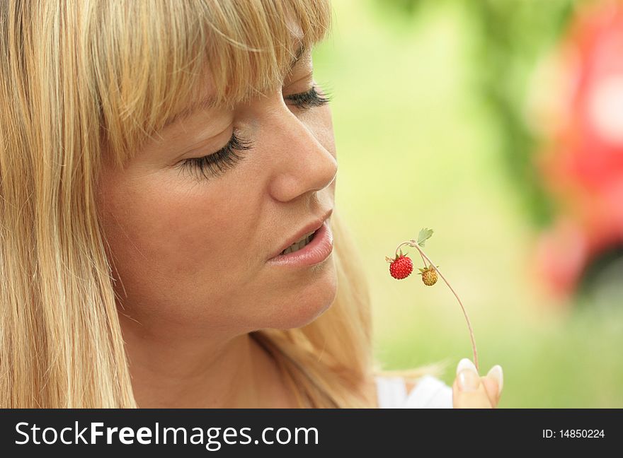Portrait of the beautiful blonde with berries in a hand. Portrait of the beautiful blonde with berries in a hand
