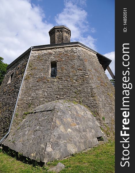 Stone mossy wall of old castle tower at bright summer day, Germany. Stone mossy wall of old castle tower at bright summer day, Germany