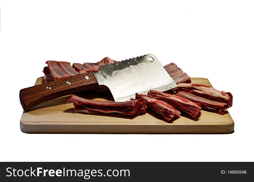 Mutton ribs and axe on chopping board. Mutton ribs and axe on chopping board