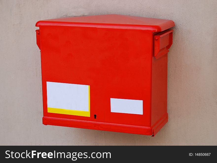 Red post box on the old wall