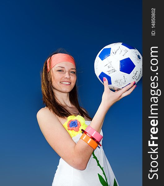Long-haired girl with ball on blue background