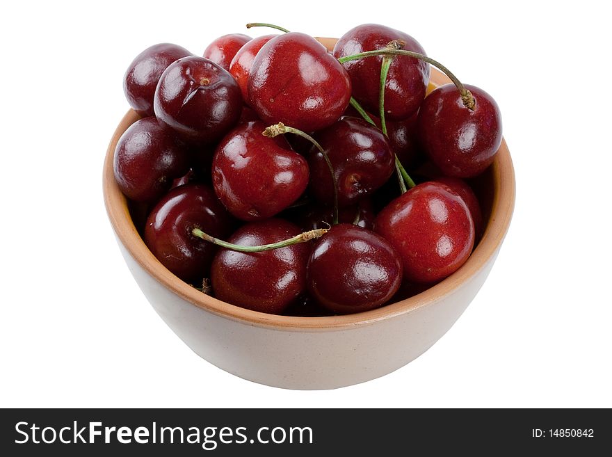 Ripe sweet cherry in a plate it is isolated on a white background