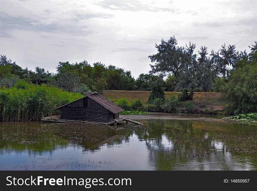Lake reflexion and old house at Sf Gheorghe in Danube Delta