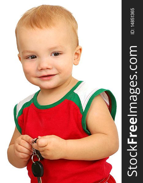Little boy holding in hands car key on white background
