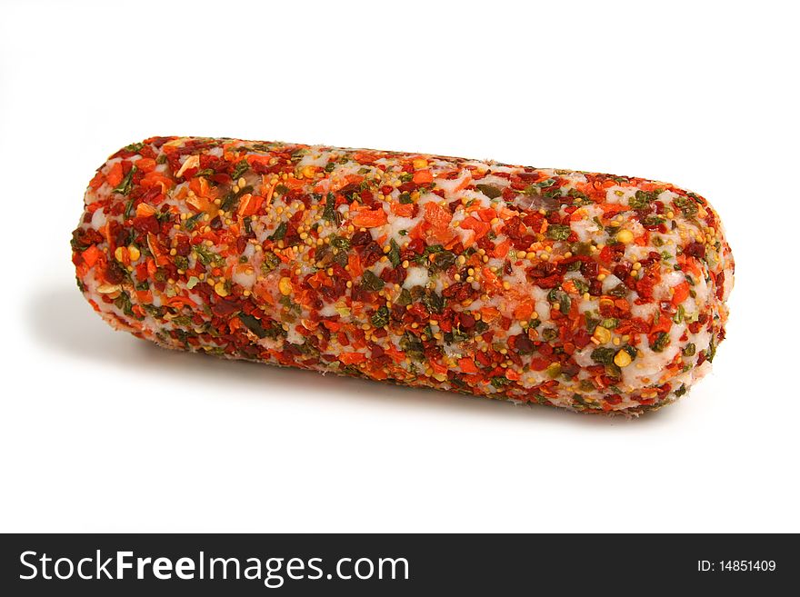 Sausage sprinkled by dried vegetables on white background