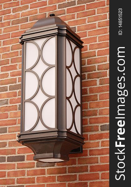 Metal sconce on brick background, outdoors wall