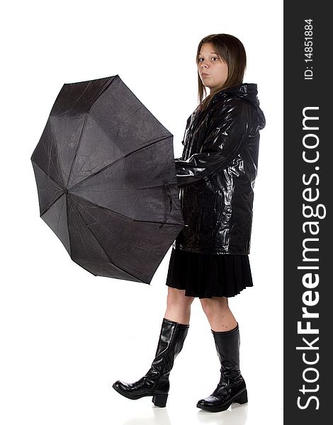 A young teen girl in rain gear, wondering if she can take her umbrella down.  Isolated on white. A young teen girl in rain gear, wondering if she can take her umbrella down.  Isolated on white.