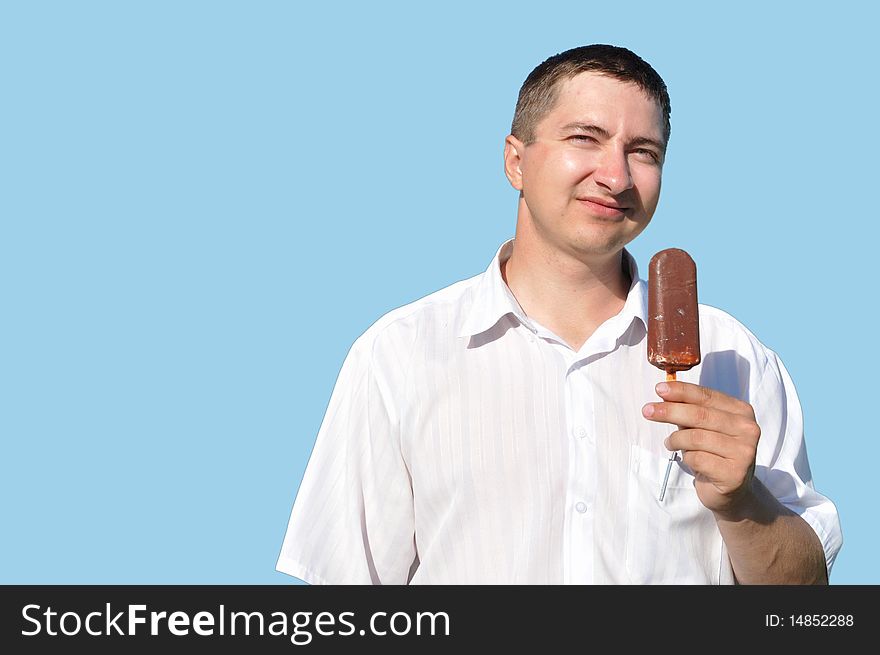 A young man eating ice cream, he is happy smiles, isolation