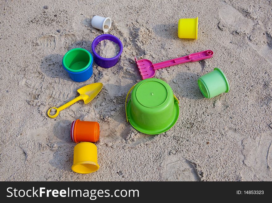 The colorful toys on sand