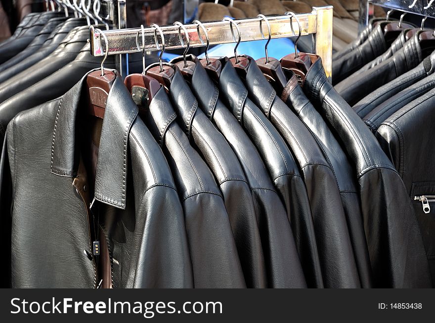 Rows black jacket on a hanger display. Rows black jacket on a hanger display