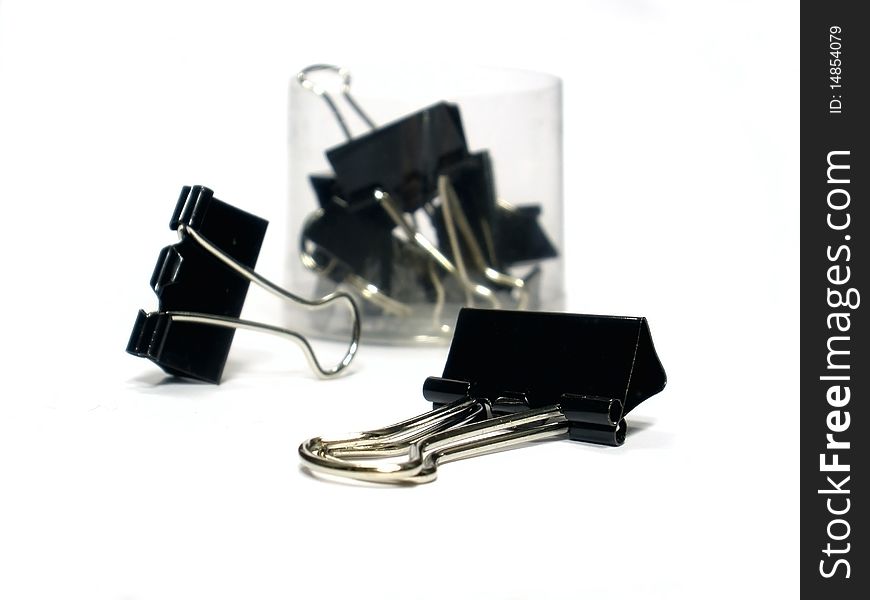 Black paper clips on the white background