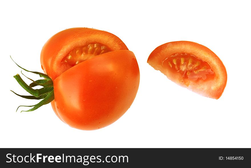 Cut red tomato with a piece on a white background