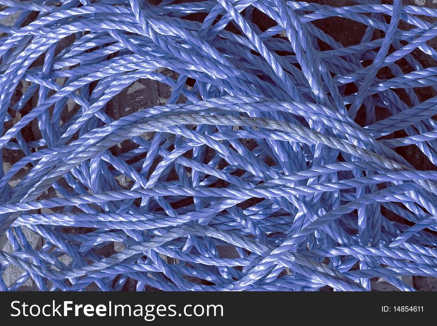 A background of blue nylon tangled rope. A background of blue nylon tangled rope