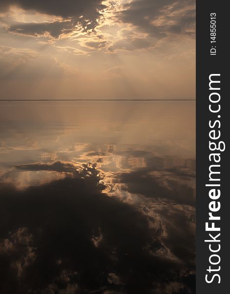 Reflection of evening light and rainy cloud on the calm water of Ubonrat dam. Reflection of evening light and rainy cloud on the calm water of Ubonrat dam